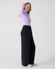 Charger l&#39;image dans la galerie, Wide black pants for women with elastic waist. DV. Lilac long sleeve turtleneck top. 
